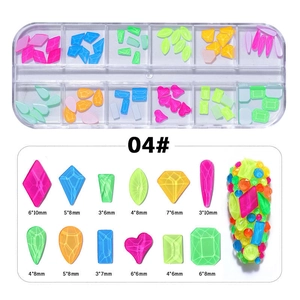 Detail of 12-grid box with neon fluorescent nail rhinestones in assorted geometric shapes