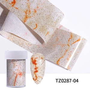 Detail of marble pattern nail transfer foil with orange veins, roll and sample nail