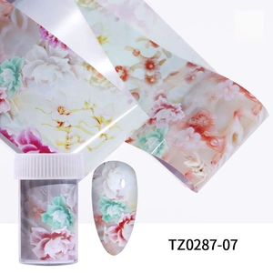 Detail of floral nail transfer foil with vintage patterns and storage container case