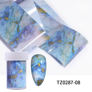 Detail of blue marble nail foil with gold flakes, roll and storage bottle for DIY nail art