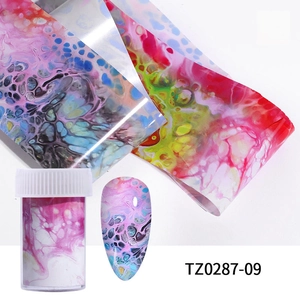 Close-up of colorful ink marble nail transfer foils and finished manicure sample