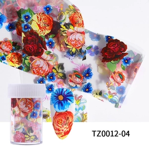 Macro detail of floral nail art foil with red roses and blue petals for DIY manicure design
