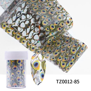 Detail of marble pattern nail art foil with holographic peacock texture and storage jar