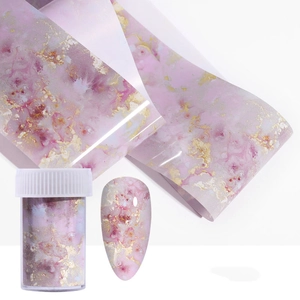 Pink marble nail transfer foil with gold leaf accents and clear storage jar for DIY art