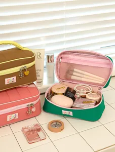 Macro detail of dopamine macaron makeup bag with wide opening and inner mesh pockets