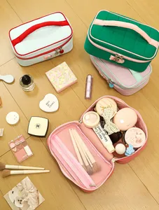 Top view of a large capacity quilted cosmetic bag with mesh pocket and makeup items