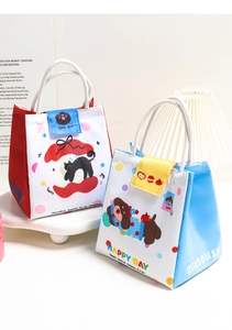 Detail of insulated lunch bags with cute cartoon cat and dog prints and cotton rope handles