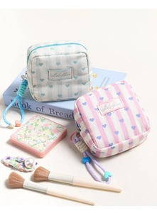 Detail of pink and blue striped heart makeup bags with woven lanyards and zipper closures