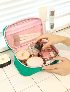 Deep interior storage of macaron makeup bag with pink lining and elastic brush slots