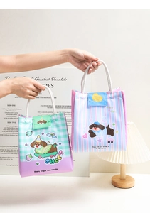 Close-up of portable cartoon lunch bags with thick handles and secure velcro closure