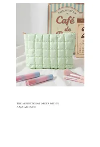 Detailed view of macaron green quilted makeup bag with square stitching and top zipper