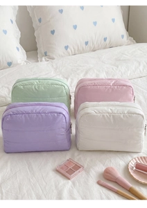 Set of four colorful quilted down makeup bags in mint green pink purple and white colors