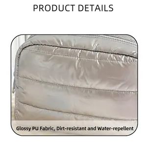 Macro detail of glossy metallic PU fabric with waterproof quilted down-style stitching