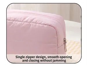 Detail of pink quilted cosmetic bag showing smooth zipper closure and fine stitching