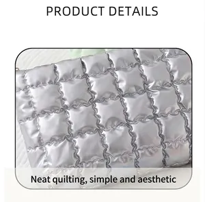 Detail view of silver quilted puffy cosmetic bag showing neat stitching and metallic texture