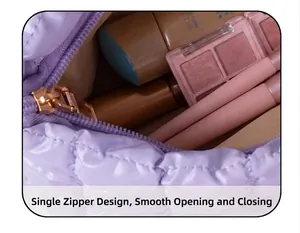 Detail of light purple quilted makeup bag featuring smooth single zipper and inner capacity