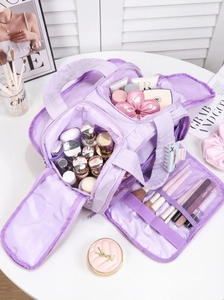 Detailed top view of large purple travel toiletry bag with brush slots and dual compartments