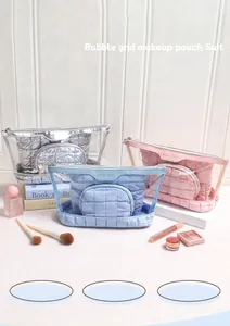Detailed view of bubble grid makeup pouch set in silver blue and pink with PVC texture