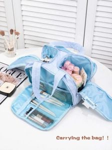 Detail of light blue travel makeup bag with multiple compartments and brush organizers