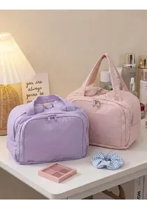 Detailed view of quilted cotton makeup bags in purple and pink on a stylish vanity