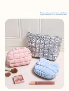 Three-piece quilted glossy toiletry bags in silver, pink, and blue with organized layout