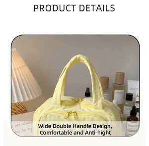 Bright yellow quilted makeup bag detail featuring wide reinforced handles and dual zippers