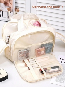 Detail of large capacity travel makeup bag with organized compartments and brush slots