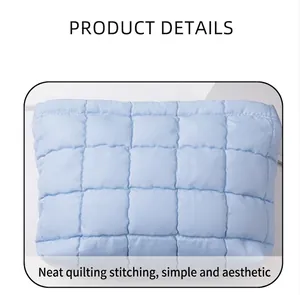 Primer plano de bolsa de maquillaje acolchada azul claro con patrón de cuadros