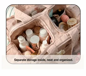 Detail view of pink quilted cosmetic bag with organized compartments and inner elastic straps