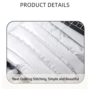 Detail of silver quilted makeup bag showing neat stitching and metallic finish surface