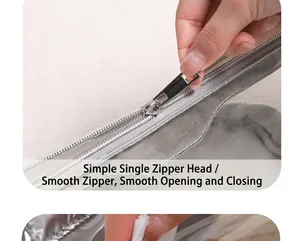 Detail of silver metallic makeup bag showing the smooth zip closure and sleek texture