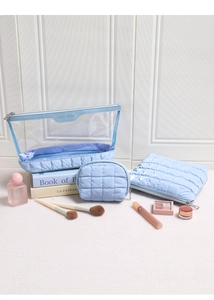 Three-piece light blue quilted makeup bag set featuring clear PVC and glossy fabric texture