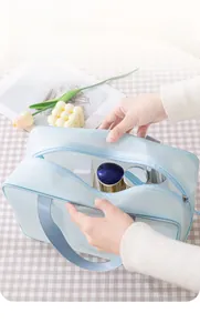 Large capacity light blue mesh makeup bag with wide opening and portable handle for travel