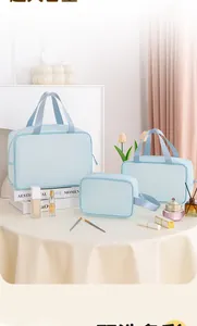 Three-piece light blue mesh makeup bag set with handles for organized travel storage