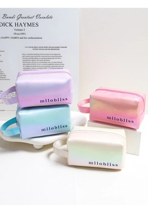 Set of four gradient iridescent cosmetic bags with pearl finish and side handles