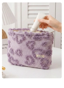 Detailed view of soft purple leopard plush makeup bag with interior storage demonstration