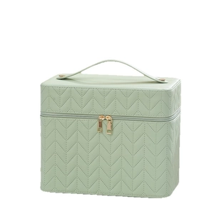 Mint green quilted faux leather makeup bag with water ripple pattern and golden zippers
