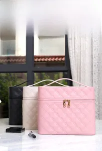 Quilted PU leather makeup bags in pink, white, and black with durable gold zippers