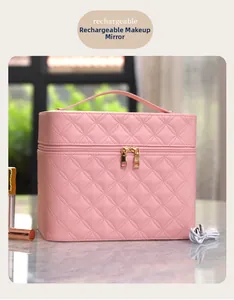 Pink quilted leather makeup case detail showing USB charging port and functional dual zippers