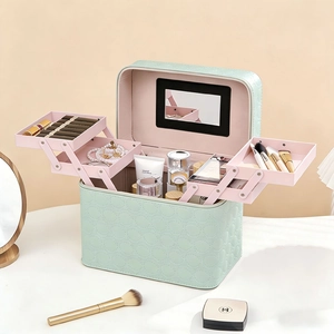 Mint green quilted leather makeup box with three-tier trays and built-in mirror