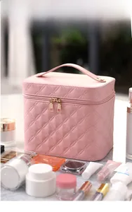 Pink quilted PU cosmetic bag with golden double zipper and spacious interior storage
