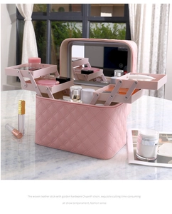 Pink diamond-quilted makeup case with an integrated LED mirror and multi-tier organizer