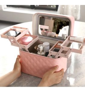 Pink quilted makeup case with LED mirror and three-tier folding storage trays