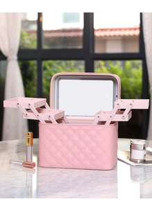 Detail view of pink quilted makeup box with multi-layer trays and built-in LED mirror