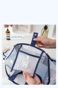 Detail view of large mesh beach bag showing side pocket for cosmetics and snap closure