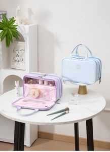 Three-layer interior detail of butterfly makeup bag with mesh pockets and zip storage