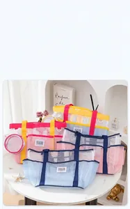 Close-up of colorful mesh beach bags with Maintain Passion labels and webbing handles