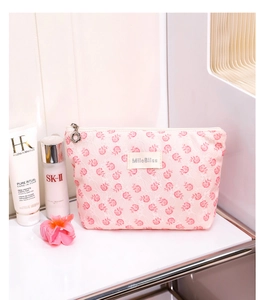 Detail of pink floral lace makeup bag with zip closure and MiloBliss label