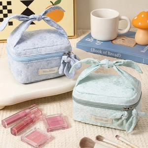 Floral lace makeup bag with large bow handle and zipper, elegant travel toiletry pouch