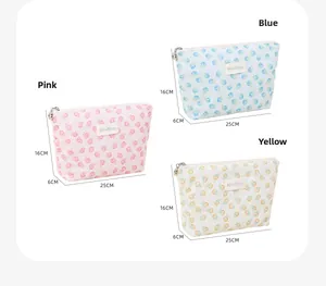 Detailed view of floral mesh makeup bags in pink, blue, and yellow with zip closure